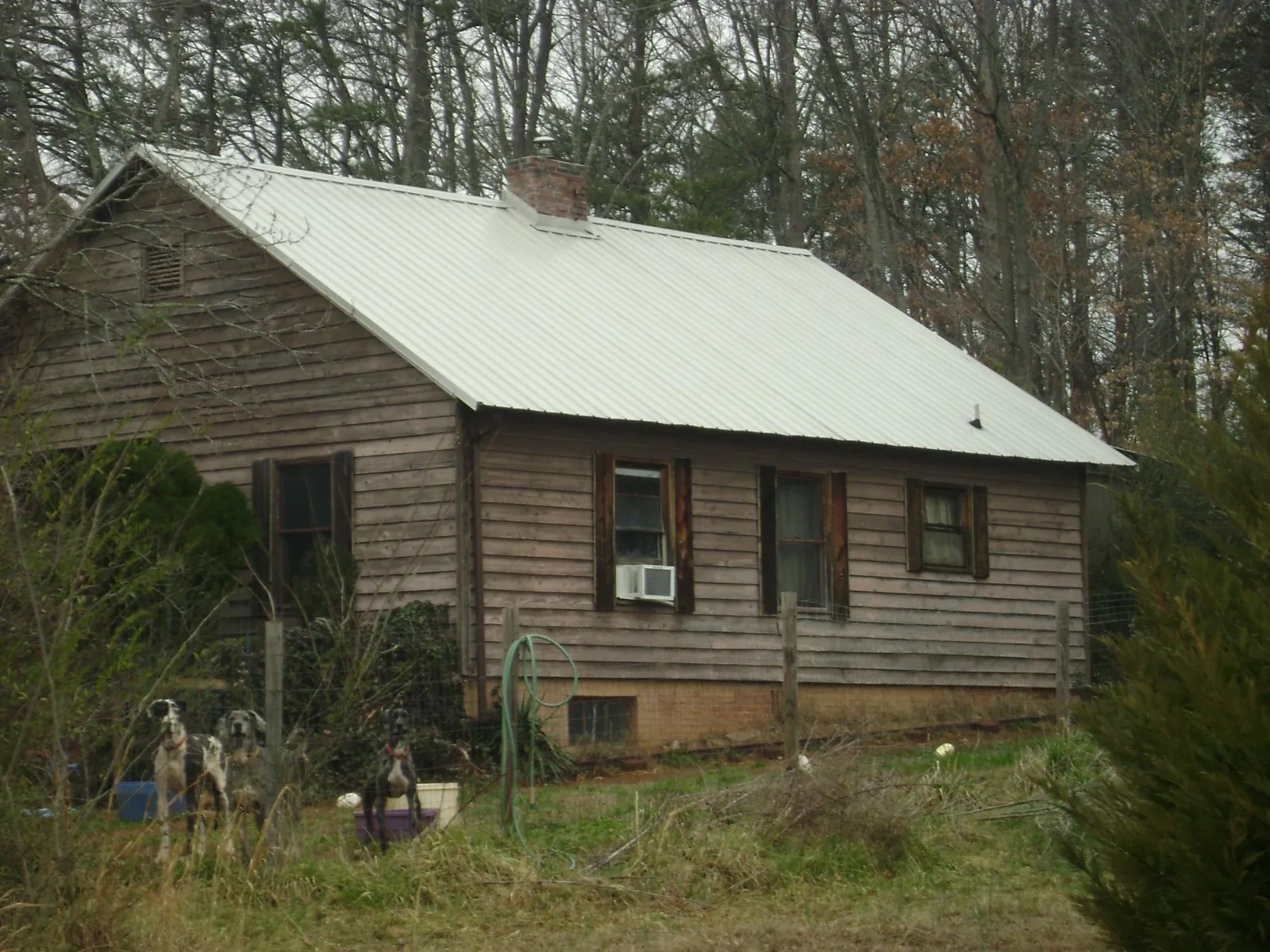 White metal roof on an old wood sided farmhouse, from a Asphalt Shingle Roof Repair job in Cramerton